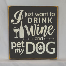 Load image into Gallery viewer, “I Just Want to Drink Wine and Pet My Dog” Funny handcrafted wood sign with an adorable paw print stamp and an image of a wine glass and bottle, 12x12 inches white font over Black. Rustic modern farmhouse home décor