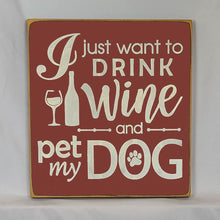 Load image into Gallery viewer, “I Just Want to Drink Wine and Pet My Dog” Funny handcrafted wood sign with an adorable paw print stamp and an image of a wine glass and bottle, 12x12 inches white font over Dark Red. Rustic modern farmhouse home décor