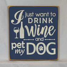 Load image into Gallery viewer, “I Just Want to Drink Wine and Pet My Dog” Funny handcrafted wood sign with an adorable paw print stamp and an image of a wine glass and bottle, 12x12 inches white font over Navy Blue. Rustic modern farmhouse home décor