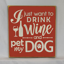 Load image into Gallery viewer, “I Just Want to Drink Wine and Pet My Dog” Funny handcrafted wood sign with an adorable paw print stamp and an image of a wine glass and bottle, 12x12 inches white font over Red. Rustic modern farmhouse home décor